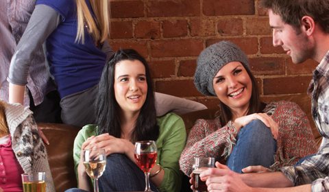 Happy young drinkers in a bar