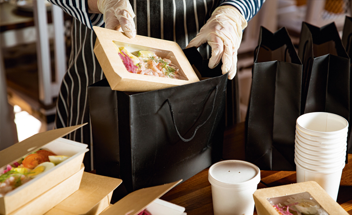 Someone putting takeaway food in their bag