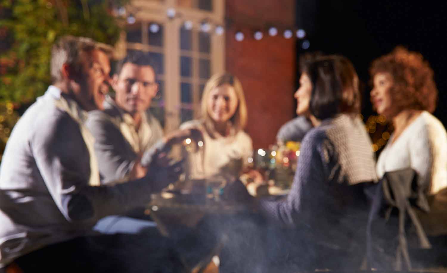 Table of friends talking outside