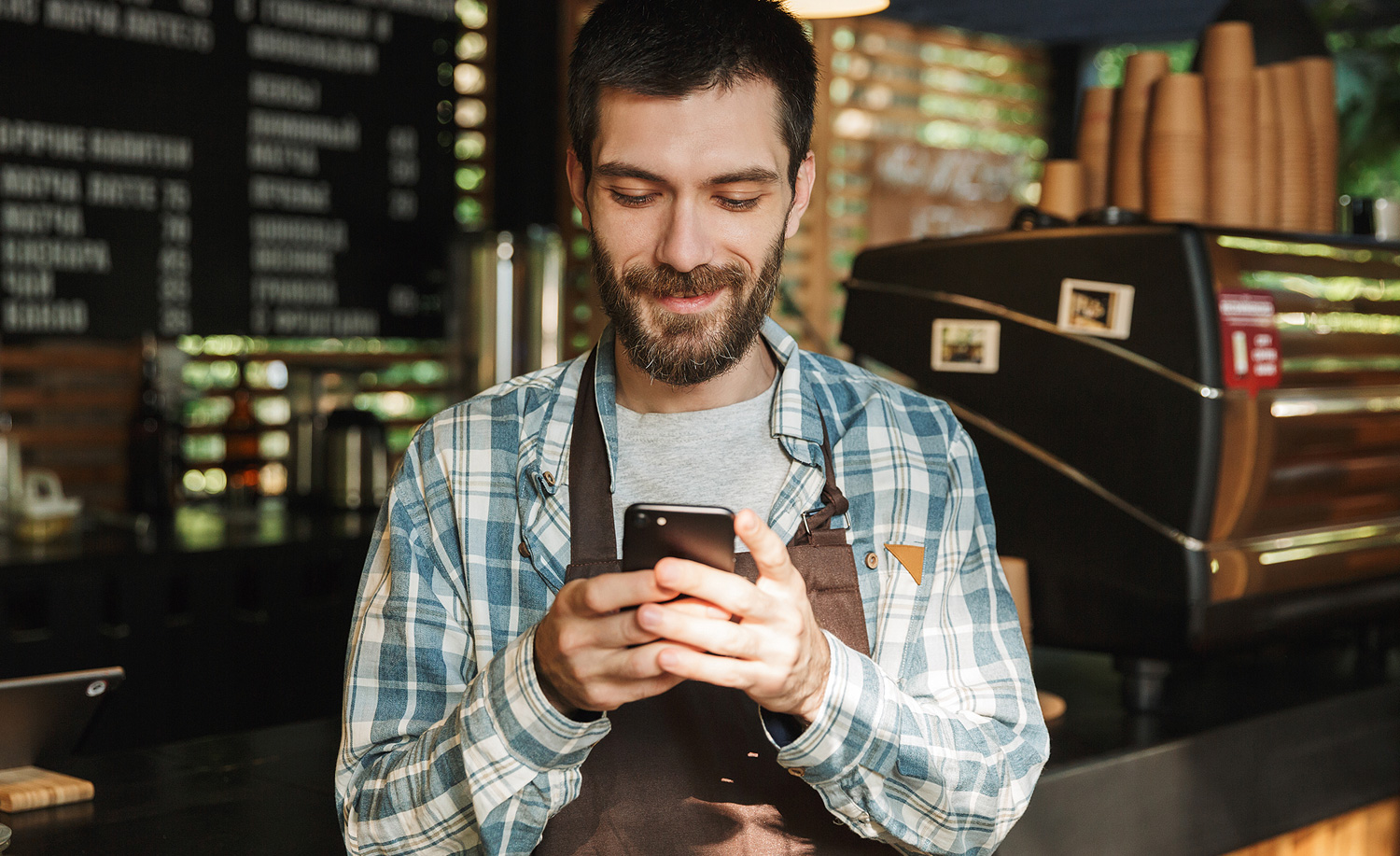 Waiter looking at phone