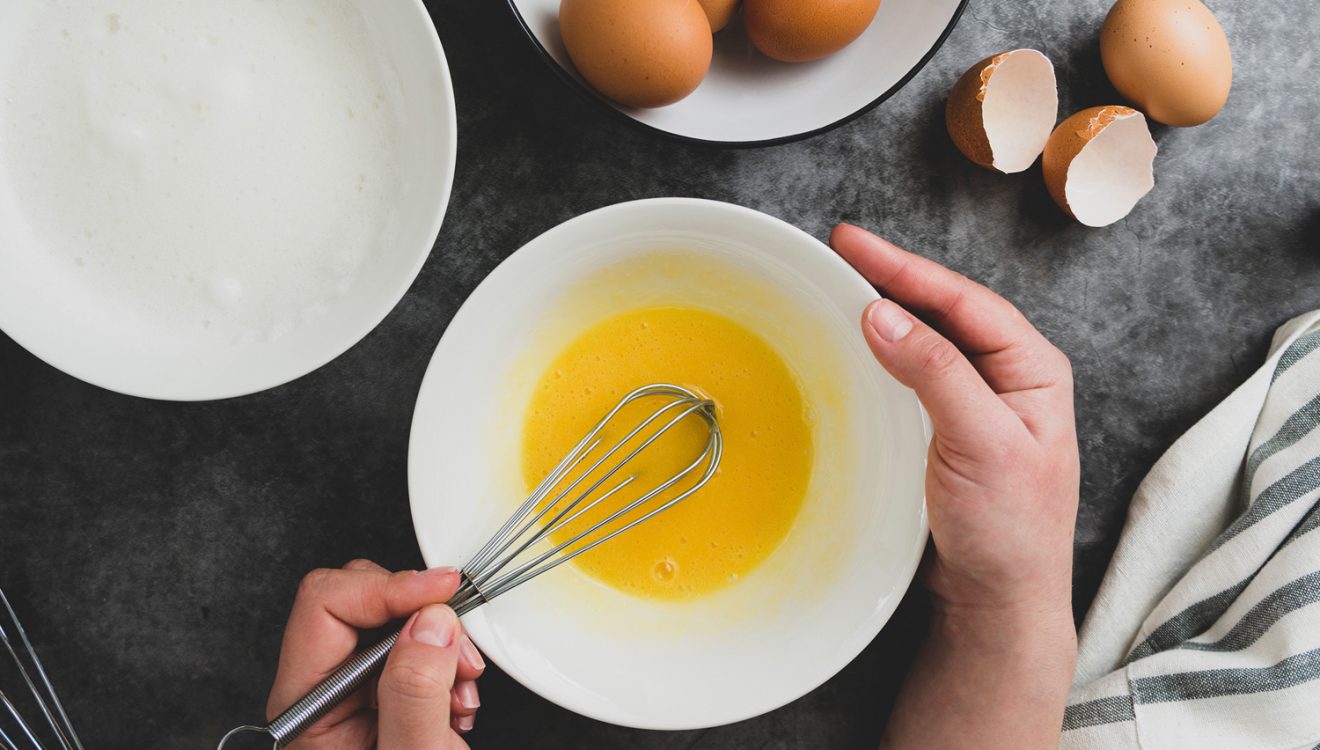 Top down view of someone whisking an egg