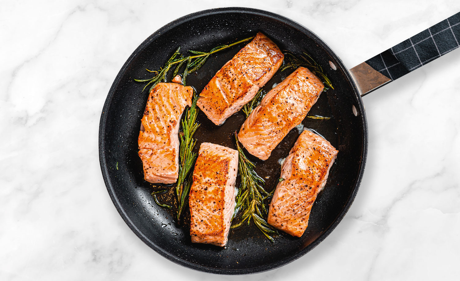 Salmon fillets cooking in a pan