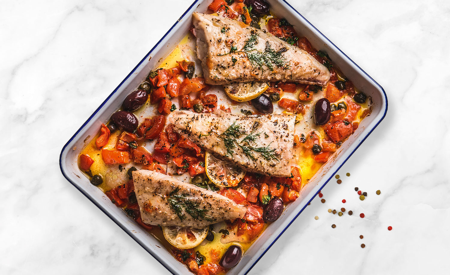 Fish and olives in oven dish