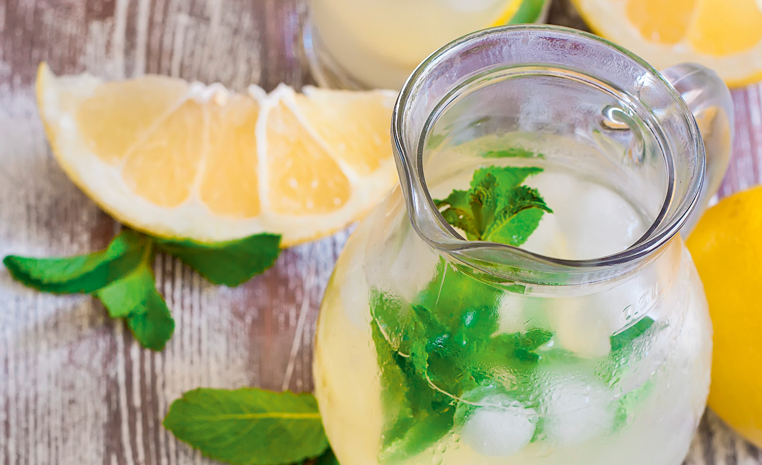 Jug of cocktail with lemon