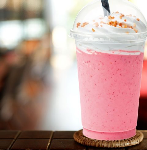 Pink milkshake in plastic cup
