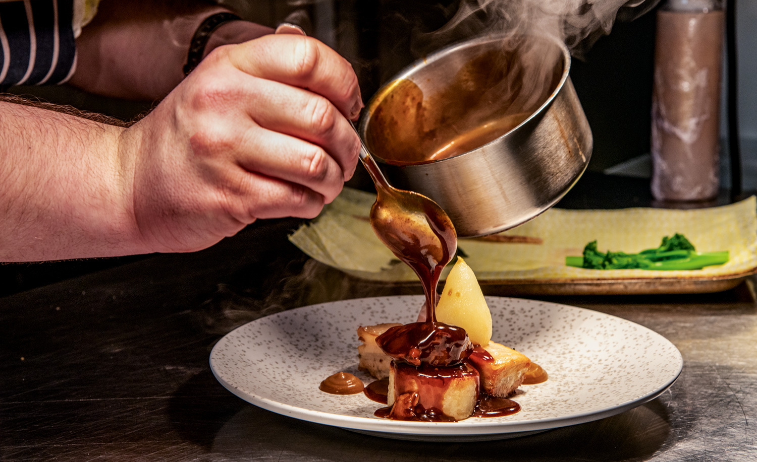 Chef dishing up plate of food at No.Thirty8, The Tower in Lincoln