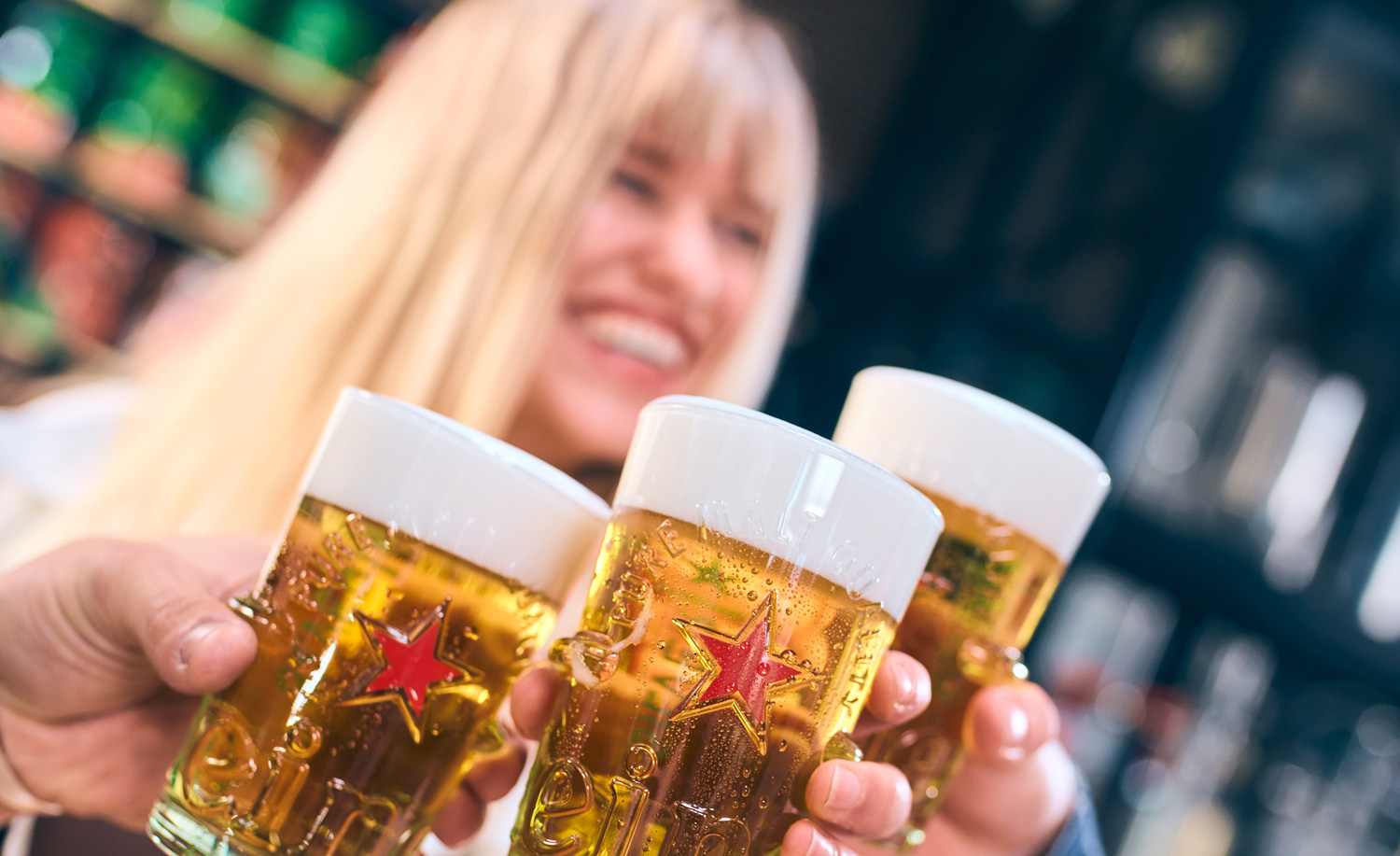 Woman in background with three pints in foreground