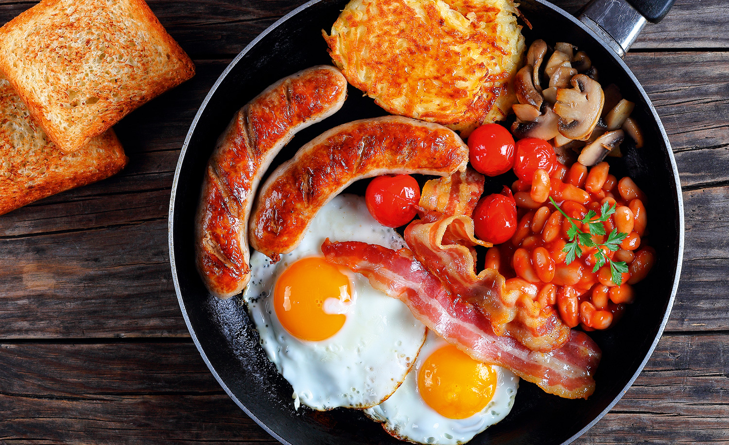 Frying pan with cooked English breakfast