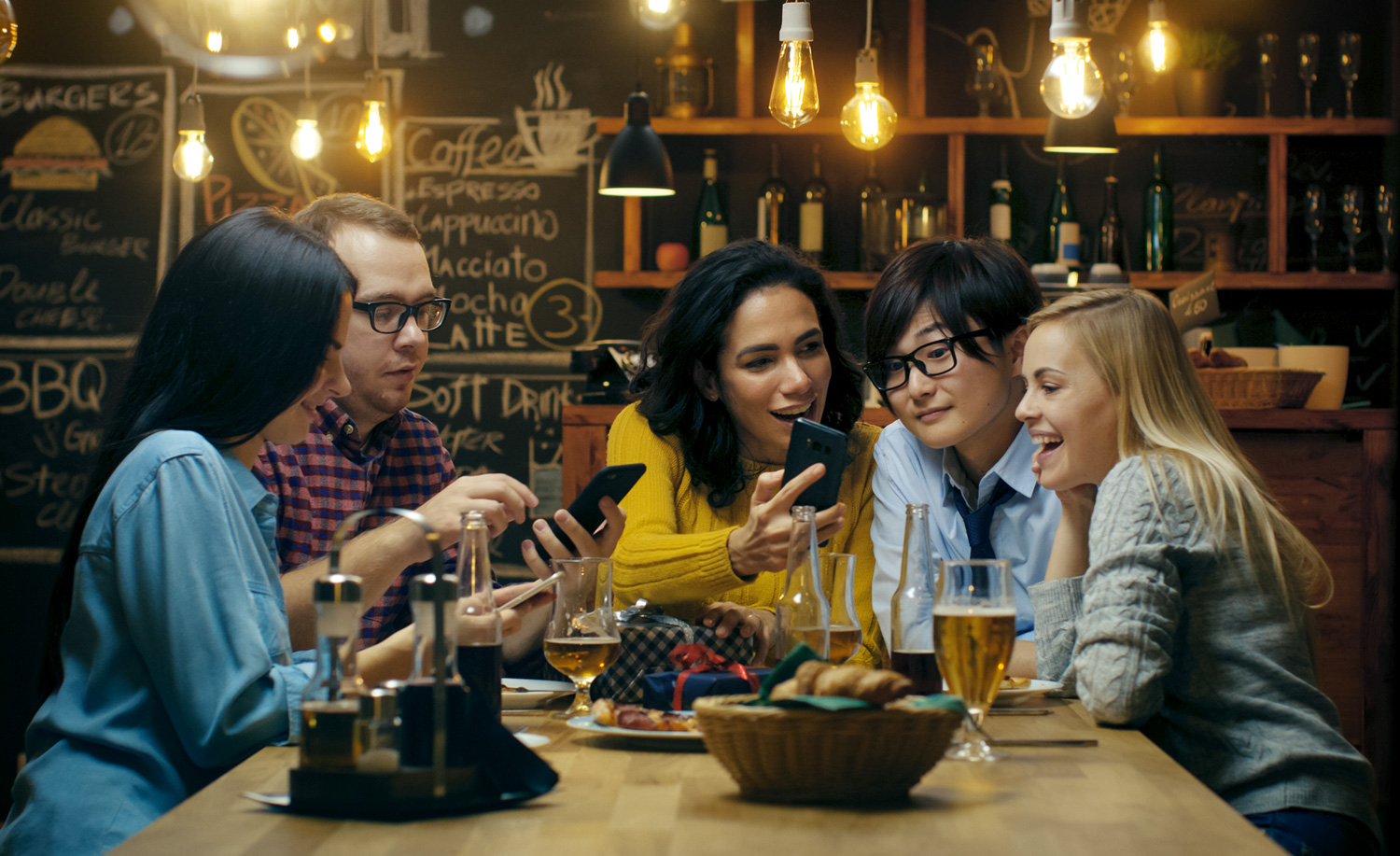 Group of friends looking at their phones