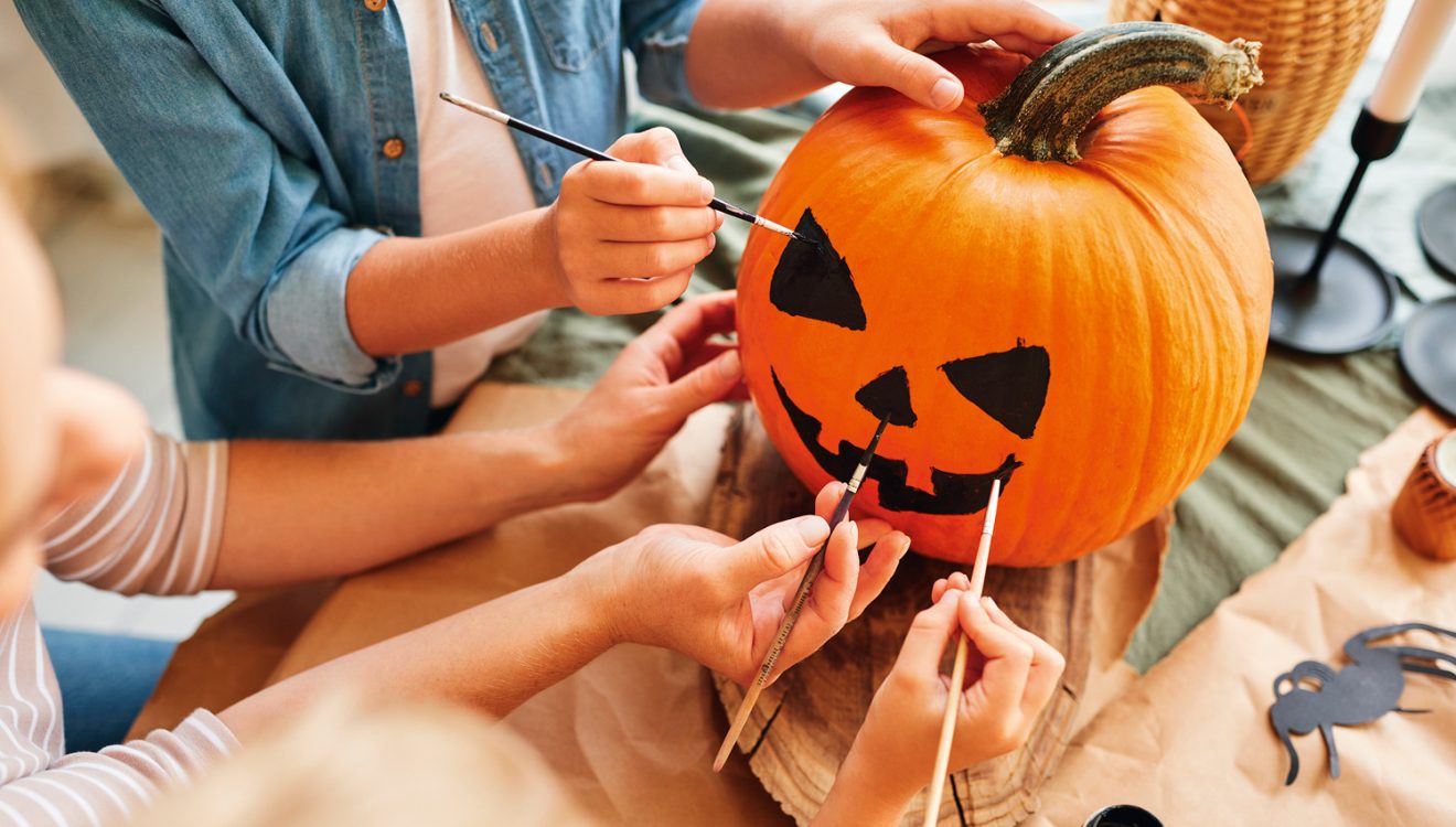 Child painting on a pumpkin