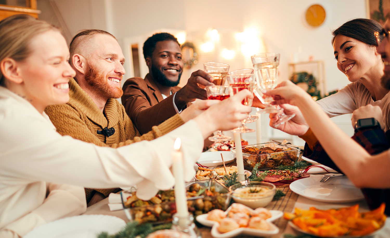 Group of friends saying cheers at Christmas meal