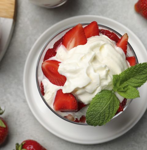 Strawberries and cream in a glass bowl