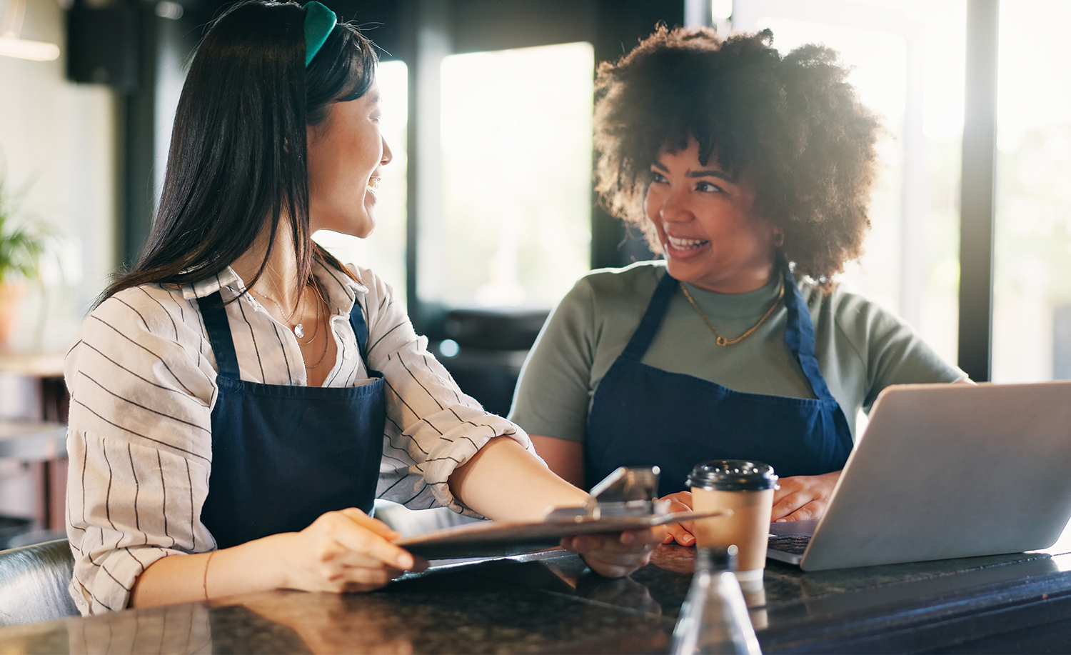 Coffee shop manager talking to a member of staff